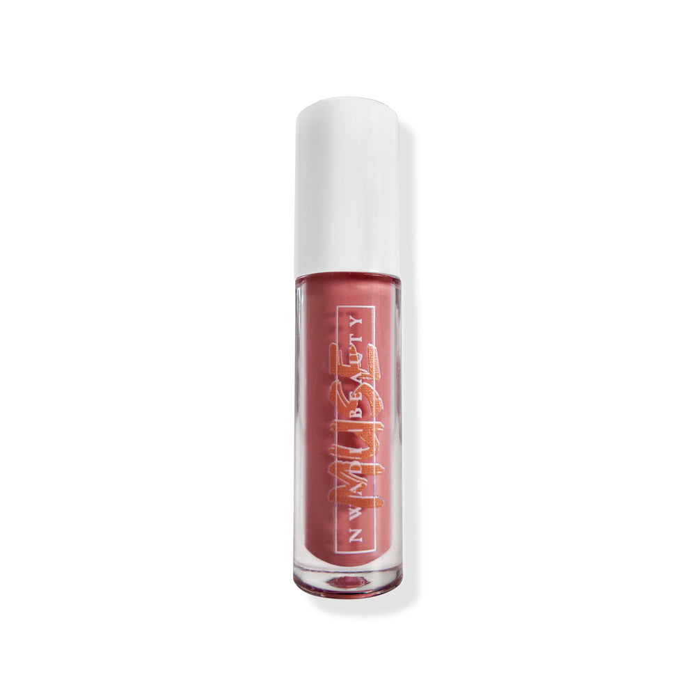 
                  
                    Matte Muse lip gloss on melanin-rich lips with velvet finish
                  
                