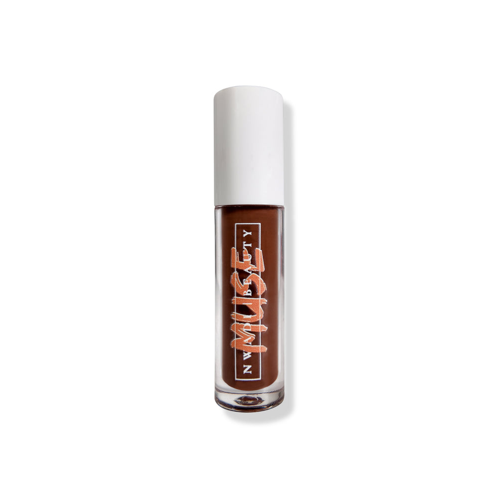 
                  
                    Matte Muse lip gloss on melanin-rich lips with velvet finish
                  
                