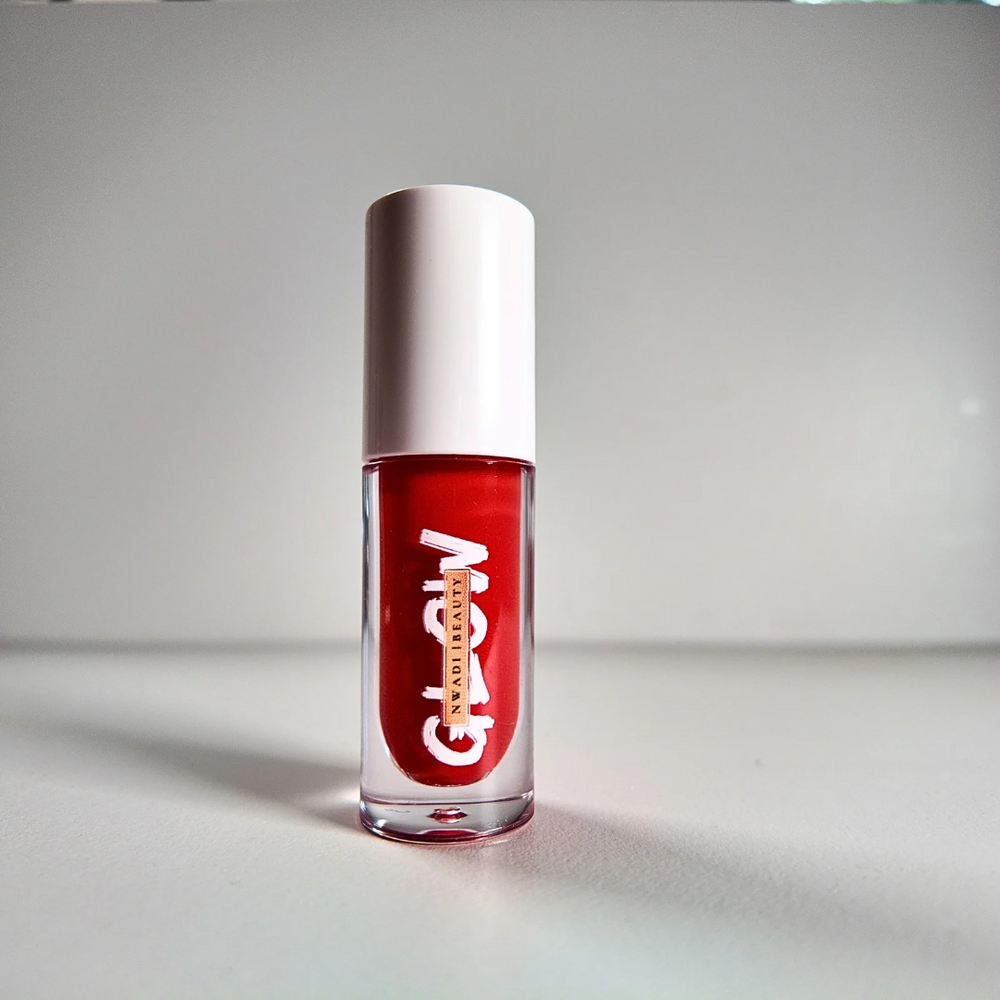 “Glossy Glow clear lip gloss swatched on dark brown skin with high-shine finish”