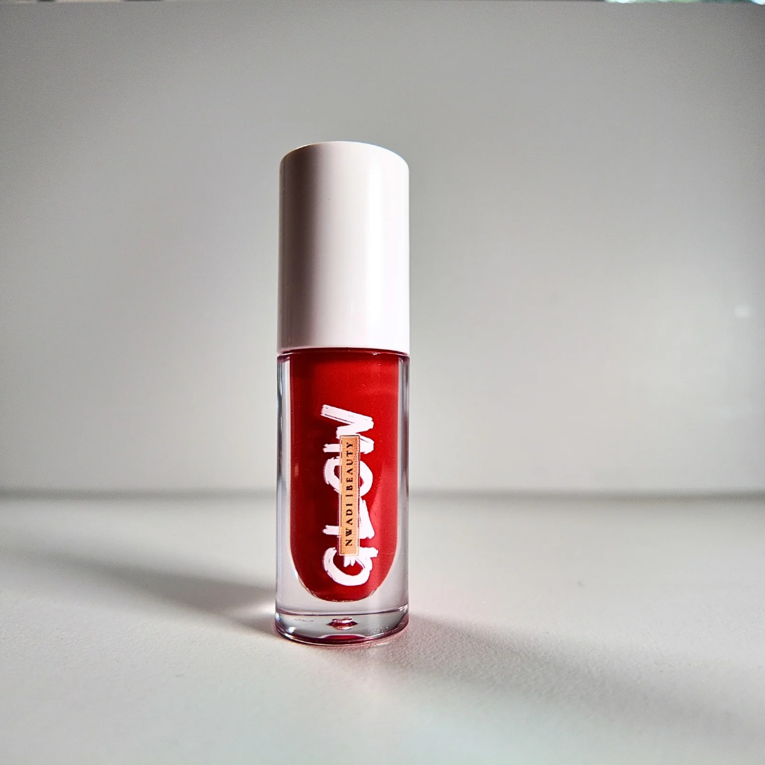 “Glossy Glow clear lip gloss swatched on dark brown skin with high-shine finish”
