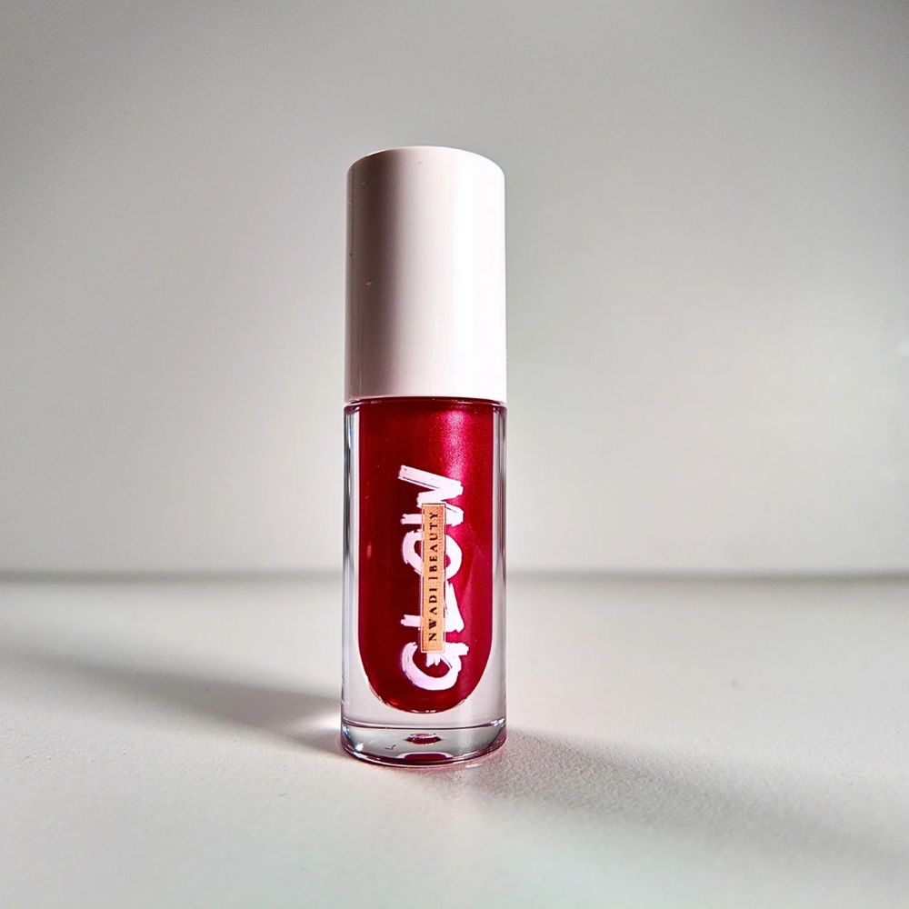 “Glossy Glow clear lip gloss swatched on dark brown skin with high-shine finish”