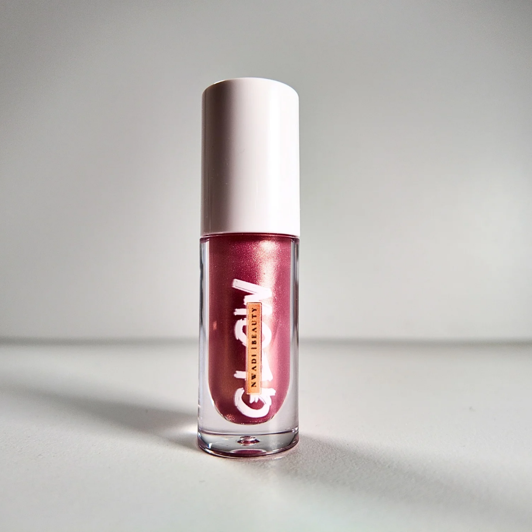 “Glossy Glow clear lip gloss swatched on dark brown skin with high-shine finish”