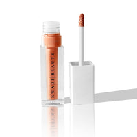 Posh nude lip gloss swatch on brown skin with soft gloss effect